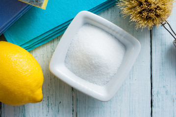 dishwashing tools and citric acid, lemon on white wooden