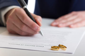 Divorce concept. Hands of wife, husband signing decree of divorce, canceling marriage, legal...