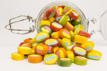 gummy candy slices in yellow, pink, green, red, orange and blue in a glass jar