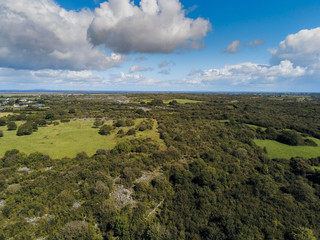 Aerial view on Irish landscape, Green fields, cloudy sky, black bales with hay, Country side, County Galway.