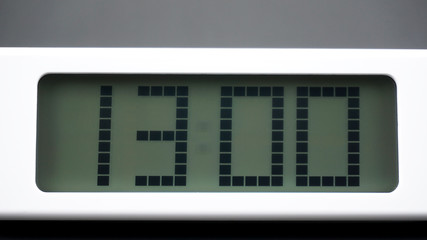 Digital alarm White clock time 13.00 am or pm on Black background, Time concept..