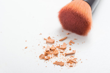 make up brush and face powder on white
