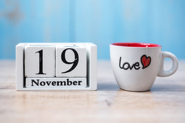 coffee cup with Black mustache on wood table background in the morning. Father, International men day, Prostate Cancer Awareness and World cancer day concept