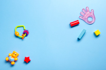 Colorful kids toys frame on wooden background. Top view. Flat lay. Copy space for text.