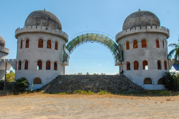 Two white towers as an entrance into abandoned amusement park in Vietnam  