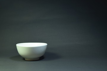 white cup on black background