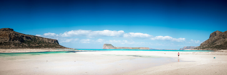 Boy walking on shore at sea