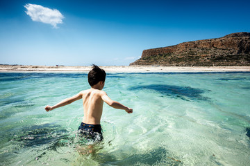 Boy enjoying in water at beach