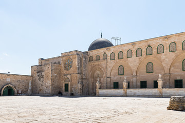 Fototapeta premium The dome and part of the wall of the Al Aqsa Mosque on the territory of the interior of the Temple Mount near the Maghrib Gate in the Old City in Jerusalem, Israel