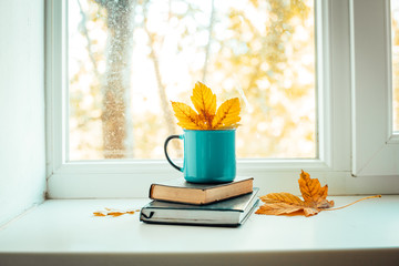 cup of coffee on the windowsill, autumn