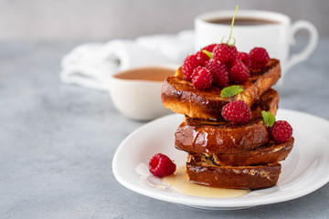French toasts, French toasts made of sliced brioche with fresh raspberries, honey and mint. Delicious breakfast or dessert