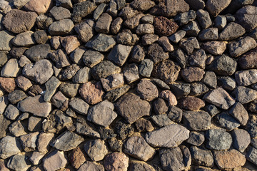 Close-up stone wall decorated with nature polished lava stones