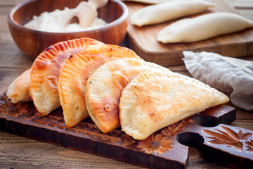 Homemade pasties on a wooden board, horizontal