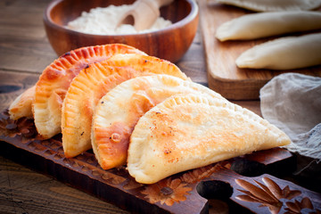 Homemade pasties on a wooden board, horizontal