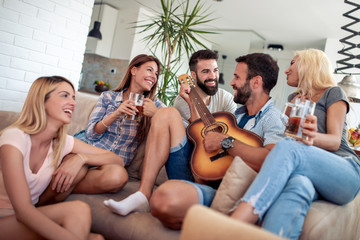 Group of friends have fun with guitar