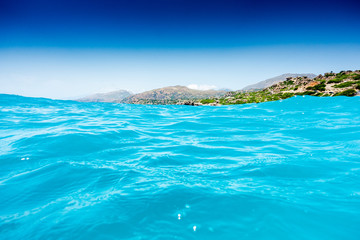 Scenic view of sea by mountain, Crete, Greece