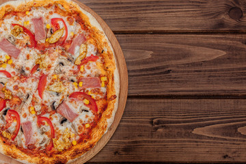 Pepperoni Pizza with Mozzarella cheese, Ham, Tomatoes, pepper, Spices . Italian pizza.
