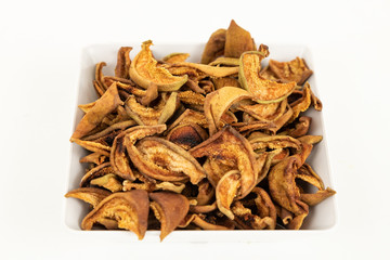 dried pear slices in white bowl on white background