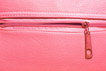 texture background of a pink leather handbag with a lock