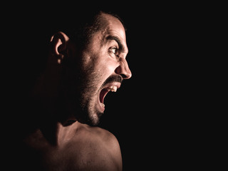 an aggressive young boy screaming