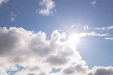 Naklejka na ściany i meble blue sky and sun shine through white clouds