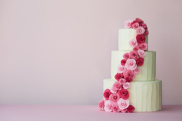 Tiered wedding cake with sugarpaste roses - obrazy, fototapety, plakaty