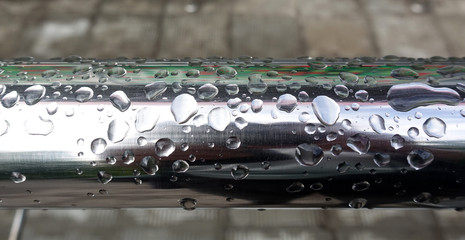 Water drops on metal railing during heavy rain