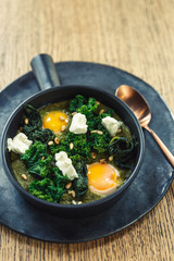 green omelette shakshuka with feta cheese and spinach