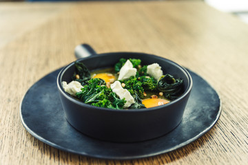 green omelette shakshuka with feta cheese and spinach