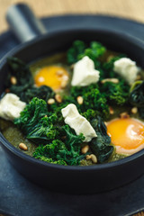 green omelette shakshuka with feta cheese and spinach