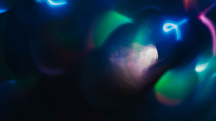 Multicolor bokeh lights. Blur glowing spots. Lens flare. Dark abstract background.