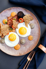 beautiful english breakfast with two eggs and pork sausage