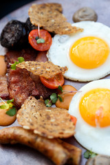 beautiful english breakfast with two eggs and pork sausage