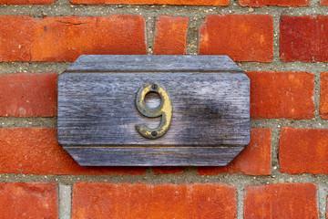 House number 9 on a wooden sign