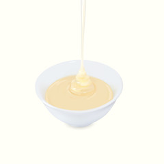 Pouring condensed milk with sugar in a bowl.