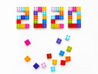New 2020 Year. Colorful constructor blocks. Toy bricks lyingwithout order. Copy space among multicolored toy details.