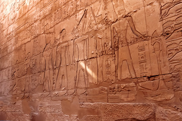 Hieroglyphs on wall of Karnak Temple Complex, famous architectural landmark in Luxor, Egypt.