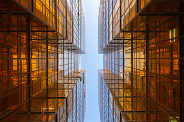 Golden building. Windows glass of modern office skyscrapers in technology and business concept....