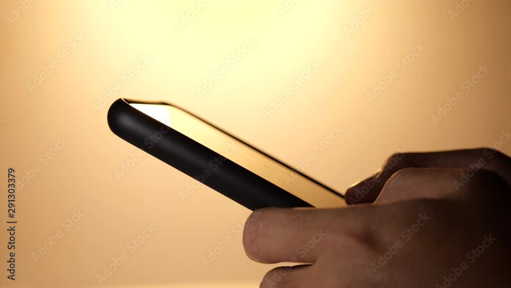 Poster Man Uses Smartphone. Man Browses Through Internet, typing text message on Smartphone. Close-up