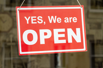 Shop sign saying yes we are open