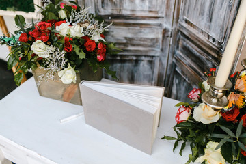 Photo album arranged on a table decorated with wood.