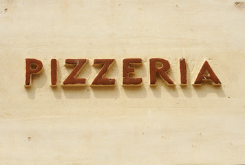 Old pizzeria sign at a wall in Italy. Handmade in ceramic material.