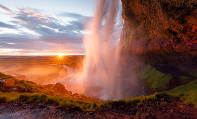 Waterfall Seljalandsfoss in Iceland, beautiful sunset golden hour scenery. - obrazy, fototapety, plakaty