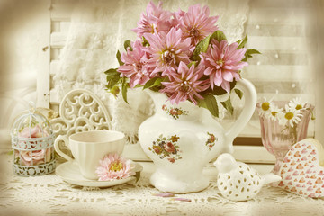 Fototapeta na wymiar bunch of pink dahlia in porcelain jug in vintage style