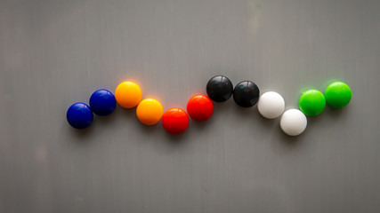 Snake emoji using the colorful fridge magnet on the refrigerator.