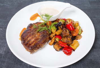 Grilled pork fillet with baked vegetables.