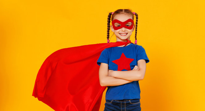 concept of child superhero costume on yellow background.