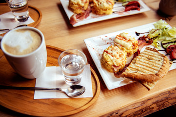 breakfast with scrambled eggs, toasts, juice and coffee