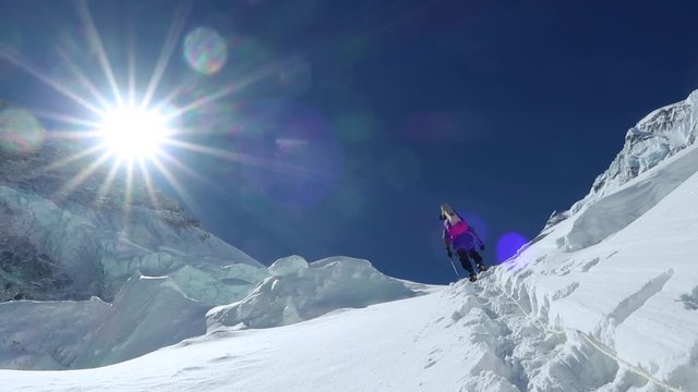 Climber reaches the summit in high  snowy mountains