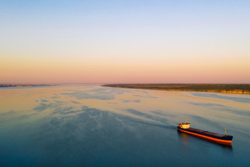 Shipping cargo to harbor by ship. Water transport International. Aerial view